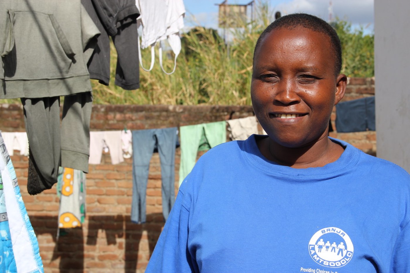Illustrative image: A community health worker outside a home
