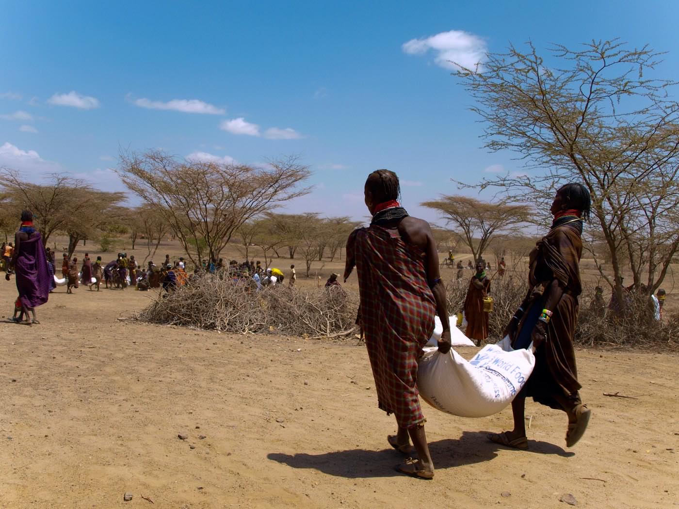 Illustrative image: Women carrying supplies in their community